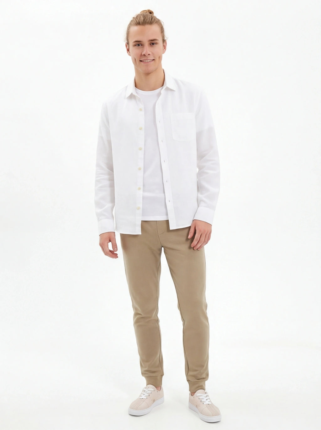 Man wearing a white shirt and beige pants on a white background